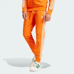 Оранжевые брюки Adidas - Спортивные брюки Adicolor Classics SST